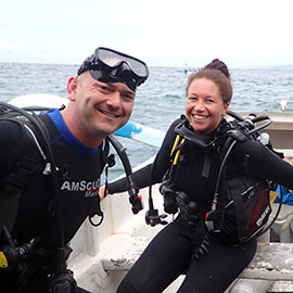 PADI Diving Courses Two scuba diving students in a full diving gear learning good diving skills with a joy and smile.